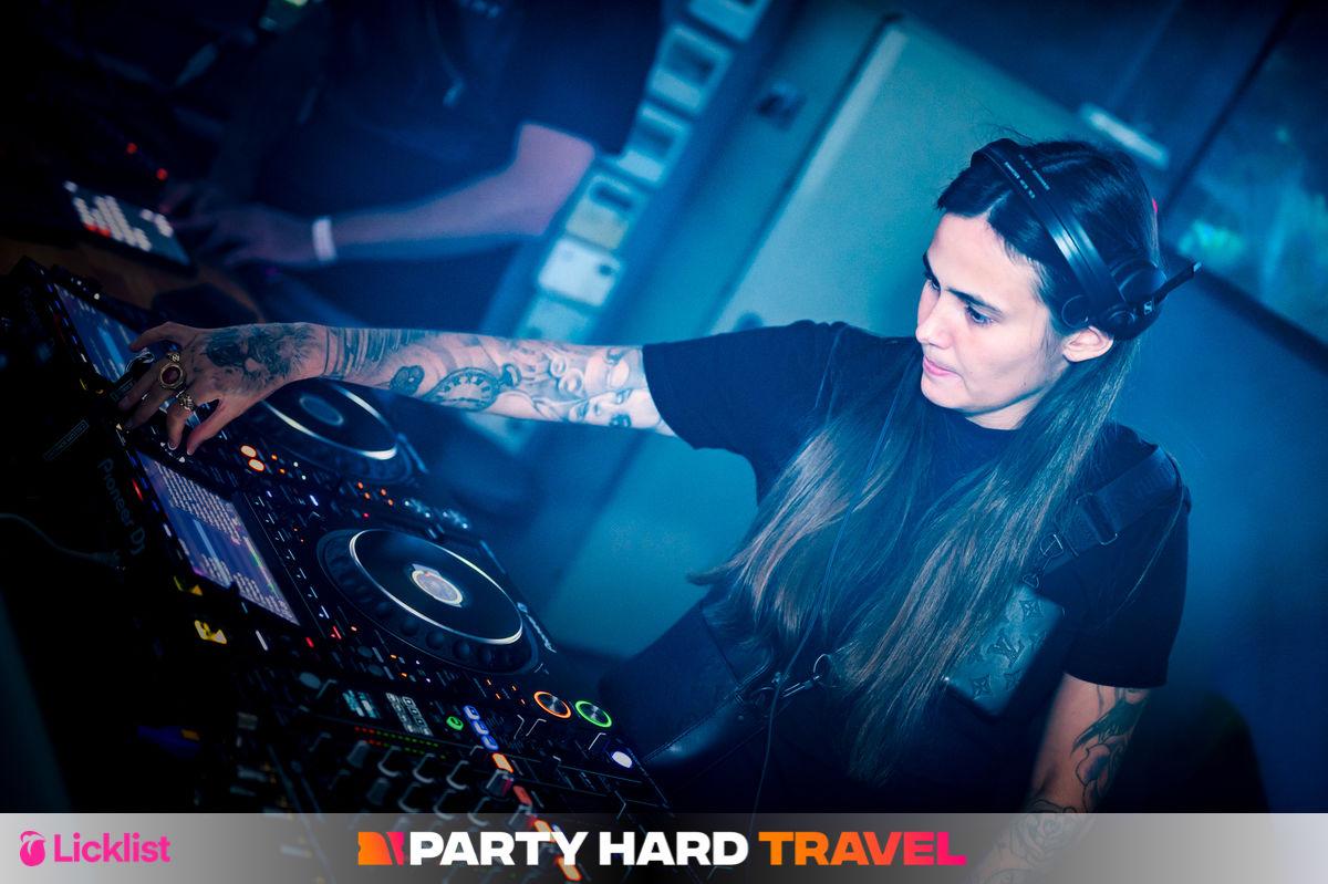Female Tattooed DJ running the Mixing Decks at Welcome to the Jungle Event in Zante